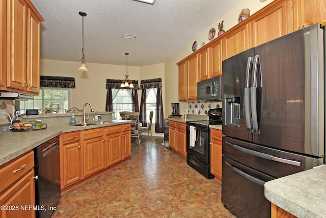 54002 Evergreen Trl, Callahan, FL 32011 - kitchen featuring black appliances, a chandelier, a peninsula, hanging light fixtures, and brown cabinets