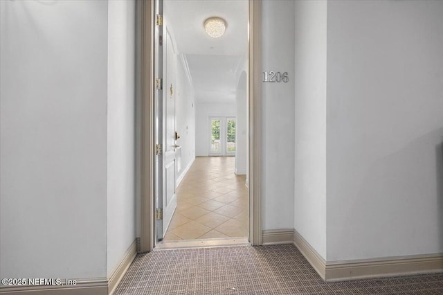 4300 S Beach Pkwy Unit 1206, Jacksonville Beach, FL 32250 - corridor featuring baseboards and light tile patterned flooring