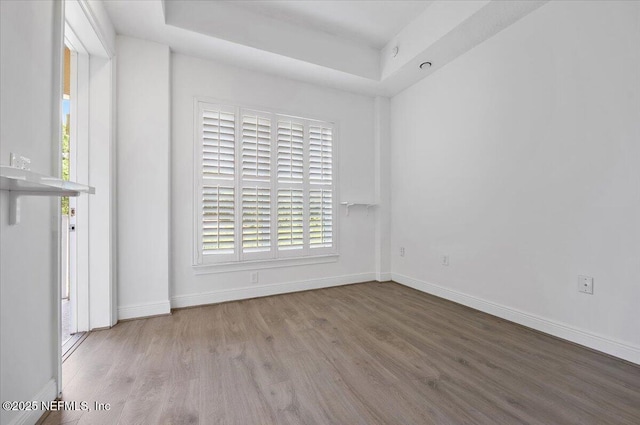 4300 S Beach Pkwy Unit 1206, Jacksonville Beach, FL 32250 - empty room with wood finished floors and a tray ceiling