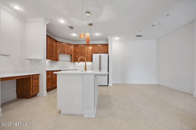 4300 S Beach Pkwy Unit 1206, Jacksonville Beach, FL 32250 - kitchen featuring ornamental molding, light countertops, freestanding refrigerator, decorative backsplash, and brown cabinetry