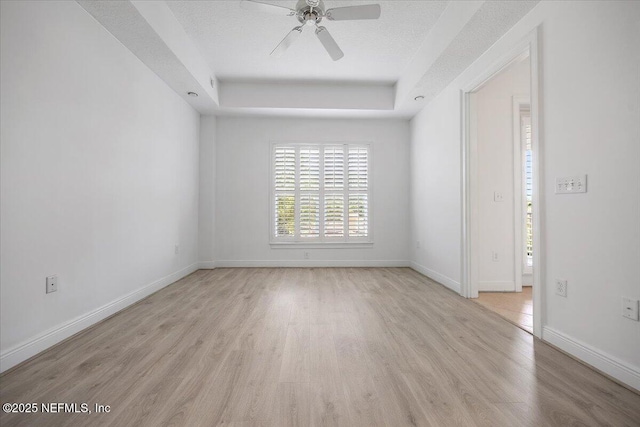 4300 S Beach Pkwy Unit 1206, Jacksonville Beach, FL 32250 - unfurnished room featuring a raised ceiling, light wood-style flooring, and ceiling fan