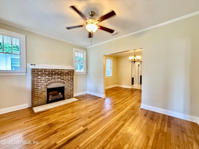4518 Astral St, Jacksonville, FL 32205 - unfurnished living room featuring a chandelier, a brick fireplace, wood finished floors, ceiling fan, and ornamental molding