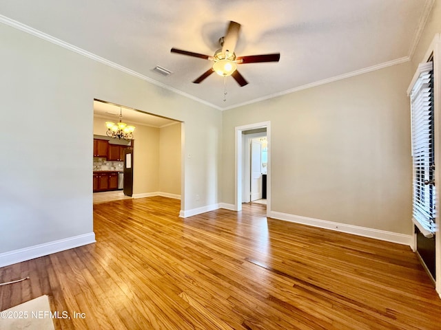 4518 Astral St, Jacksonville, FL 32205 - unfurnished living room featuring a chandelier, a ceiling fan, light wood finished floors, and ornamental molding