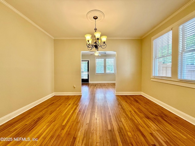 4518 Astral St, Jacksonville, FL 32205 - unfurnished room featuring a chandelier, wood finished floors, and crown molding