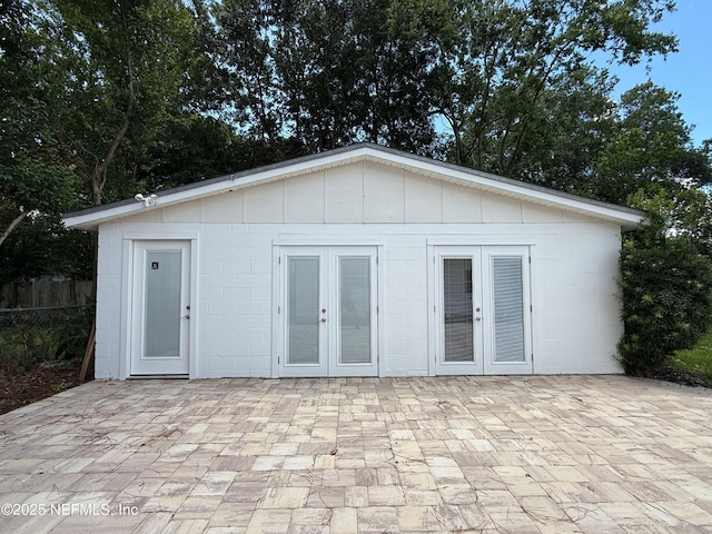4518 Astral St, Jacksonville, FL 32205 - rear view of house featuring french doors, concrete block siding, a patio, and board and batten siding
