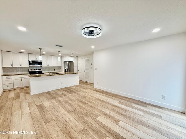 4518 Astral St, Jacksonville, FL 32205 - kitchen with appliances with stainless steel finishes, dark countertops, recessed lighting, light wood-style floors, and decorative light fixtures