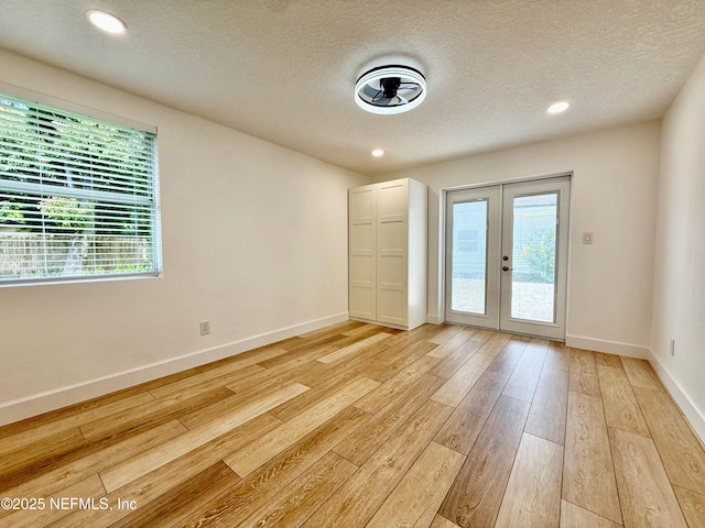 4518 Astral St, Jacksonville, FL 32205 - unfurnished room with french doors, light wood finished floors, a textured ceiling, and recessed lighting