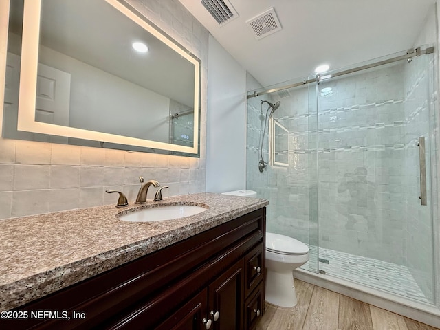 4518 Astral St, Jacksonville, FL 32205 - full bathroom with vanity, a shower stall, wood finished floors, backsplash, and recessed lighting