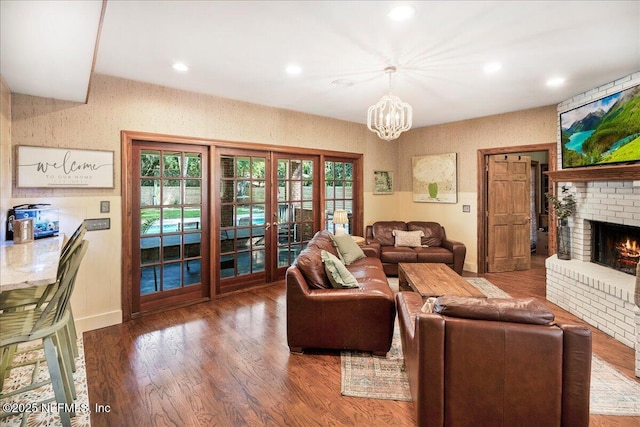 2748 Scott Mill Ter, Jacksonville, FL 32257 - living area with a chandelier, a fireplace, wood finished floors, recessed lighting, and french doors