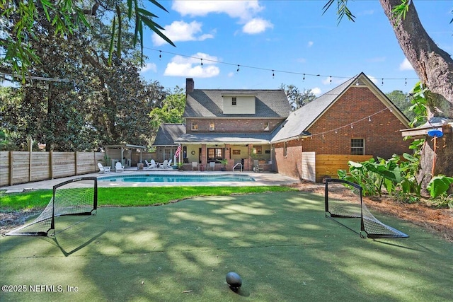 2748 Scott Mill Ter, Jacksonville, FL 32257 - rear view of property with a chimney, a patio, and brick siding