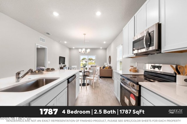 3559 Mildred Way, Jacksonville, FL 32254 - kitchen with appliances with stainless steel finishes, open floor plan, recessed lighting, light countertops, and a chandelier