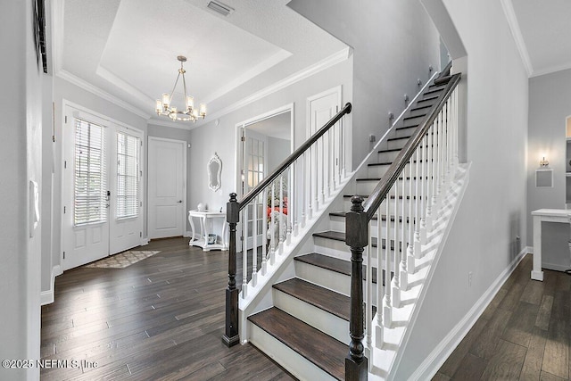 195 Glenneyre Cir, Saint Augustine, FL 32092 - entryway with a chandelier, wood finished floors, stairs, arched walkways, and ornamental molding