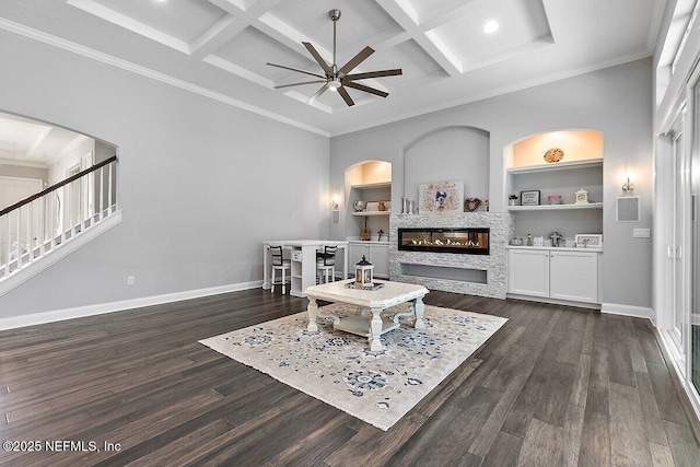 195 Glenneyre Cir, Saint Augustine, FL 32092 - living room featuring a ceiling fan, coffered ceiling, a glass covered fireplace, dark wood-type flooring, and beamed ceiling