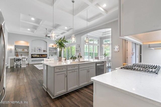 195 Glenneyre Cir, Saint Augustine, FL 32092 - kitchen with gray cabinetry, coffered ceiling, a ceiling fan, a glass covered fireplace, and appliances with stainless steel finishes