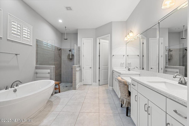 195 Glenneyre Cir, Saint Augustine, FL 32092 - full bath with a tile shower, two vanities, a freestanding bath, and tile patterned floors