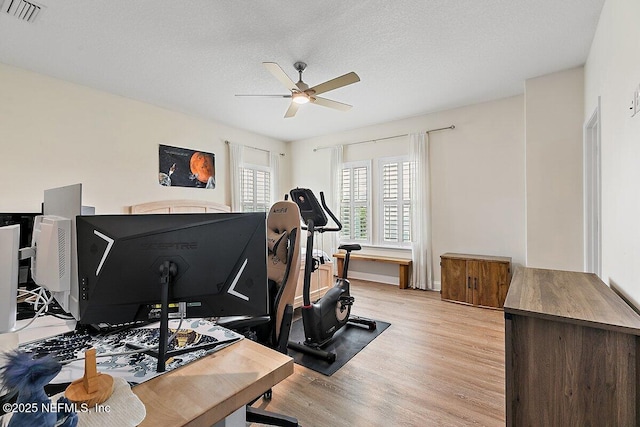 195 Glenneyre Cir, Saint Augustine, FL 32092 - workout room featuring a ceiling fan, light wood finished floors, and a textured ceiling