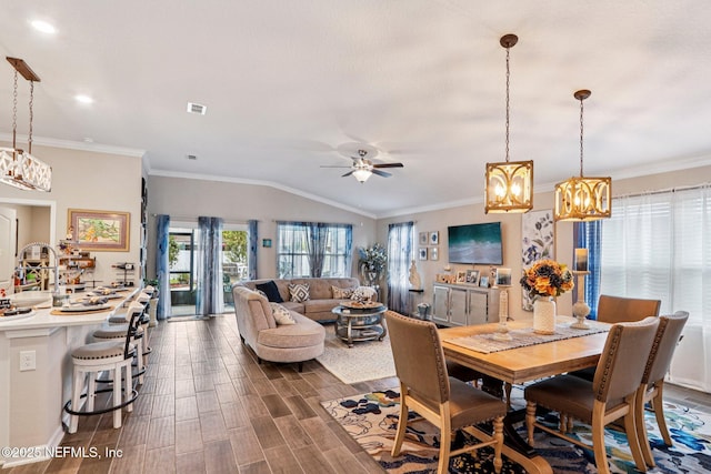 44 Spotted Owl Ln, Saint Augustine, FL 32095 - dining room featuring a chandelier, ceiling fan, lofted ceiling, dark wood finished floors, and crown molding