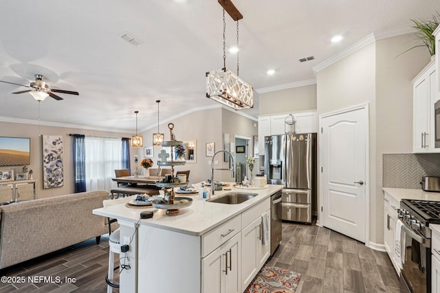 44 Spotted Owl Ln, Saint Augustine, FL 32095 - kitchen with stainless steel appliances, dark wood finished floors, open floor plan, a ceiling fan, and light countertops