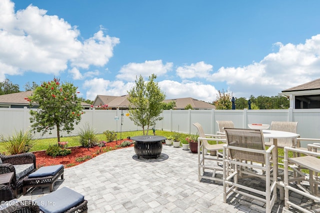 44 Spotted Owl Ln, Saint Augustine, FL 32095 - fenced backyard featuring a patio, outdoor dining area, and a fire pit