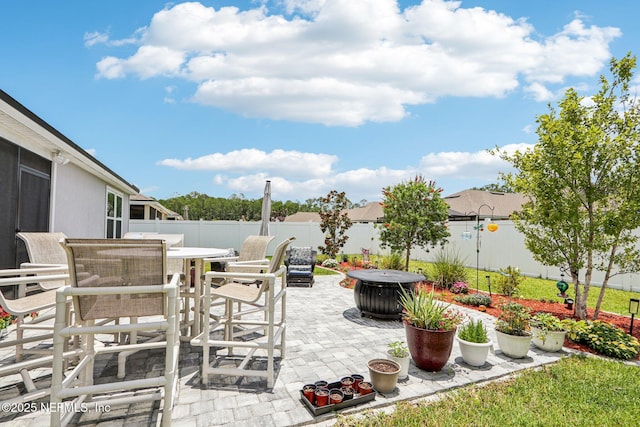 44 Spotted Owl Ln, Saint Augustine, FL 32095 - fenced backyard featuring outdoor dining area, a patio area, and an outdoor fire pit