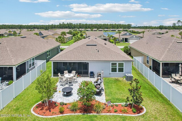 44 Spotted Owl Ln, Saint Augustine, FL 32095 - rear view of house featuring a residential view, a sunroom, a fenced backyard, a patio, and roof with shingles
