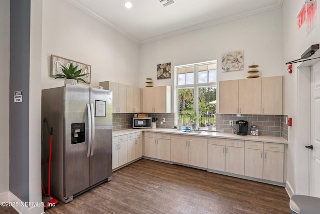 44 Spotted Owl Ln, Saint Augustine, FL 32095 - kitchen with stainless steel appliances, light countertops, dark wood-type flooring, backsplash, and ornamental molding
