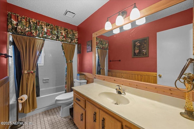 1179 Kincross Ct, Orange Park, FL 32065 - full bathroom featuring shower / bath combo with shower curtain, vanity, wainscoting, tile patterned flooring, and a textured ceiling