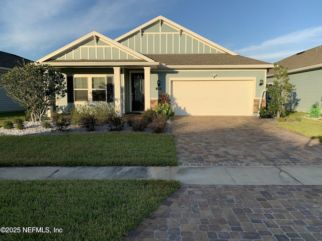 488 Broomsedge Cir, Saint Augustine, FL 32095 - view of front facade with decorative driveway, a front lawn, and a garage