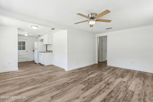 9043 8th Ave, Jacksonville, FL 32208 - unfurnished living room with light wood-style floors and ceiling fan