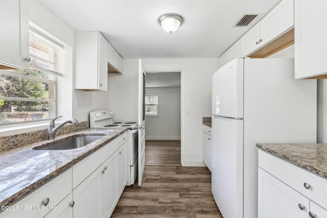 9043 8th Ave, Jacksonville, FL 32208 - kitchen with white appliances, dark wood-type flooring, white cabinets, and light stone counters