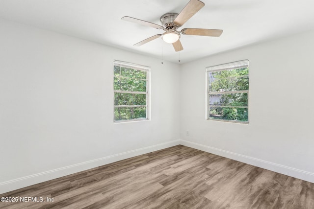 9043 8th Ave, Jacksonville, FL 32208 - unfurnished room featuring healthy amount of natural light, wood finished floors, and ceiling fan