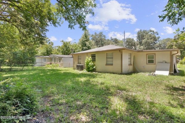 9043 8th Ave, Jacksonville, FL 32208 - back of house featuring concrete block siding and view of scattered trees