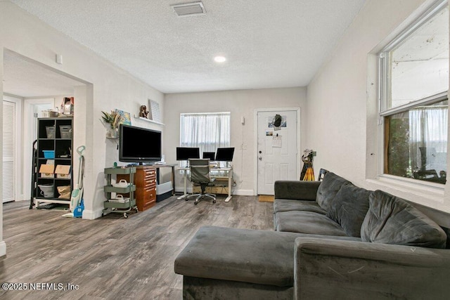 950 Ashton St, Jacksonville, FL 32208 - living area with a desk, wood finished floors, and a textured ceiling