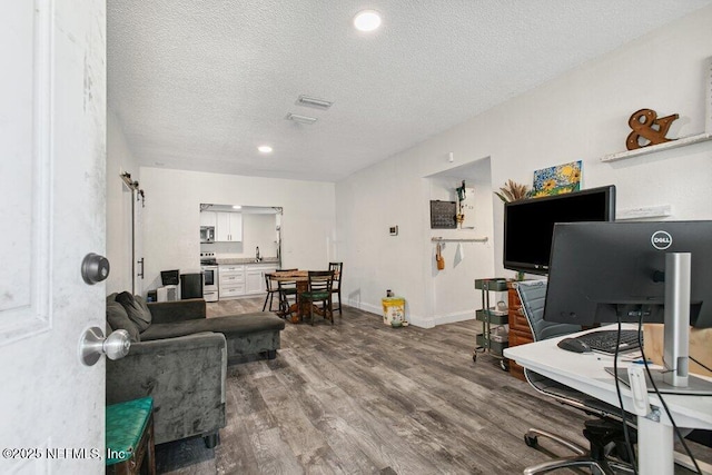 950 Ashton St, Jacksonville, FL 32208 - living room with an office area, dark wood-style floors, and a textured ceiling
