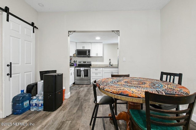 950 Ashton St, Jacksonville, FL 32208 - dining room with a barn door and wood finished floors