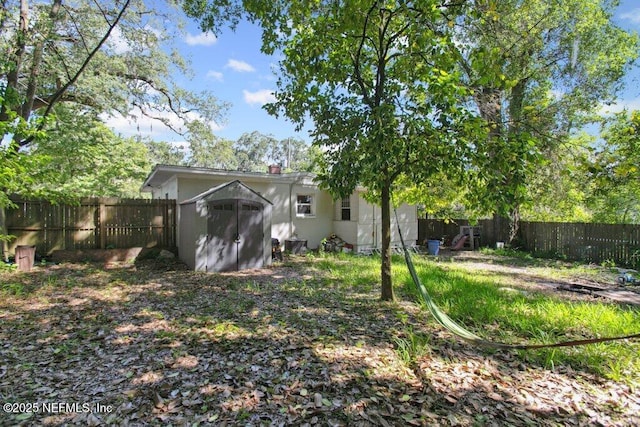 950 Ashton St, Jacksonville, FL 32208 - fenced backyard featuring a storage unit