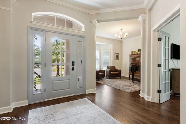 95006 Buckeye Ct, Fernandina Beach, FL 32034 - foyer with dark wood-style flooring, a chandelier, and ornamental molding