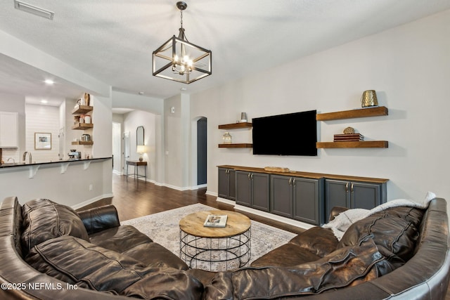 95006 Buckeye Ct, Fernandina Beach, FL 32034 - living area with dark wood-type flooring, arched walkways, a chandelier, and recessed lighting