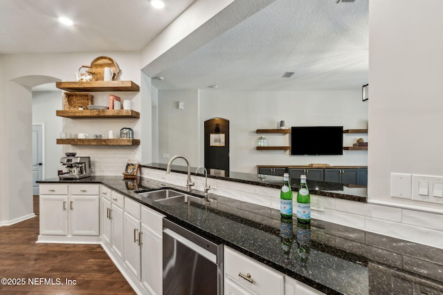 95006 Buckeye Ct, Fernandina Beach, FL 32034 - kitchen featuring stainless steel dishwasher, arched walkways, open shelves, dark stone countertops, and dark wood-style floors