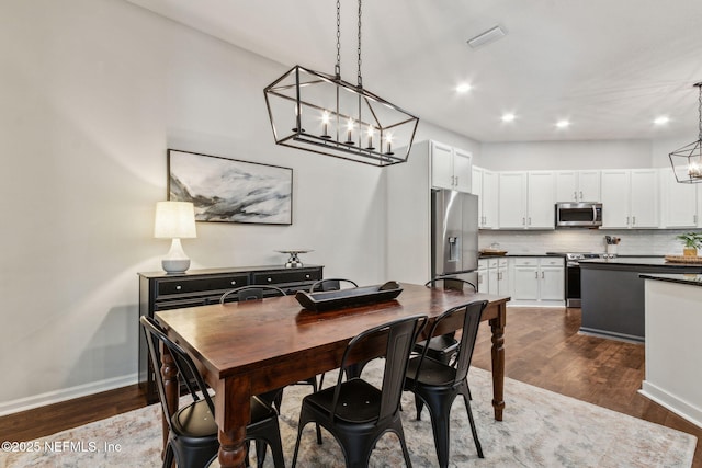 95006 Buckeye Ct, Fernandina Beach, FL 32034 - dining room with a chandelier, dark wood-style flooring, and recessed lighting