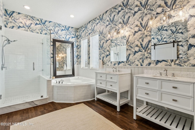 95006 Buckeye Ct, Fernandina Beach, FL 32034 - full bath with wallpapered walls, a stall shower, wood finished floors, a garden tub, and two vanities