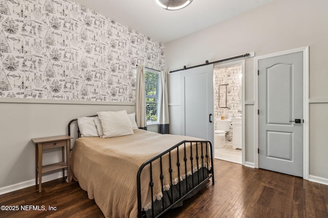 95006 Buckeye Ct, Fernandina Beach, FL 32034 - bedroom featuring hardwood / wood-style flooring, a barn door, connected bathroom, and wallpapered walls