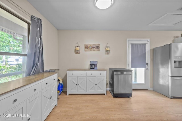 1331 Sheffield Rd, Saint Johns, FL 32259 - kitchen with stainless steel refrigerator with ice dispenser, white cabinetry, light wood-style floors, and light countertops