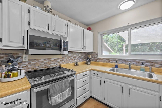 1331 Sheffield Rd, Saint Johns, FL 32259 - kitchen featuring appliances with stainless steel finishes, light countertops, and white cabinets