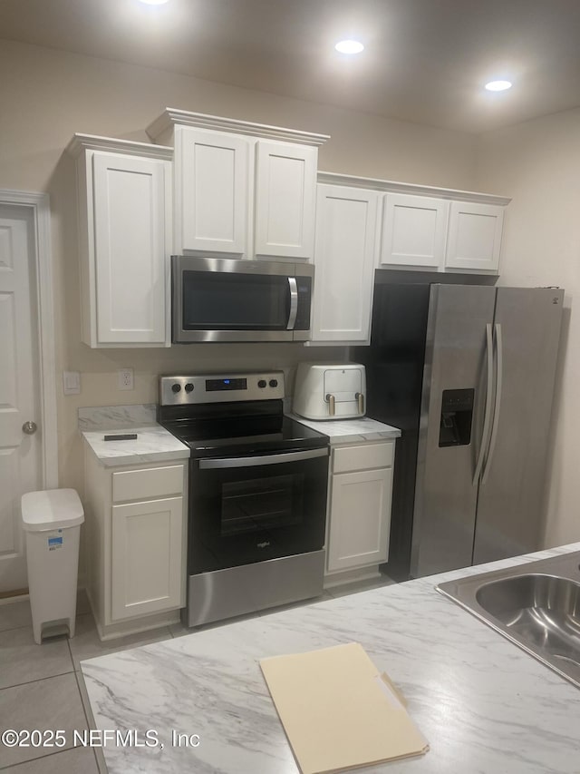 86568 Shortline Cir, Yulee, FL 32097 - kitchen with stainless steel appliances, light countertops, white cabinetry, and recessed lighting