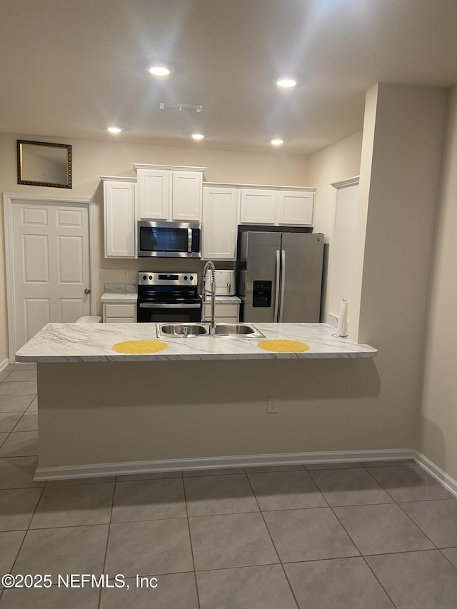 86568 Shortline Cir, Yulee, FL 32097 - kitchen featuring stainless steel appliances, white cabinets, light tile patterned floors, and recessed lighting