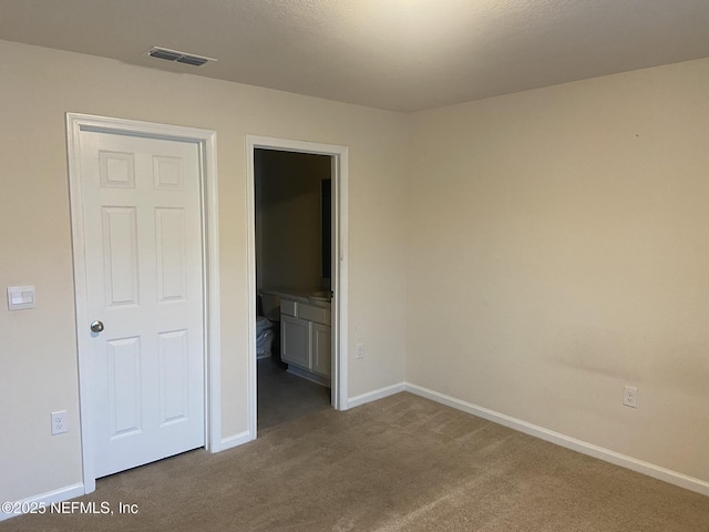 86568 Shortline Cir, Yulee, FL 32097 - unfurnished bedroom with dark colored carpet and ensuite bathroom