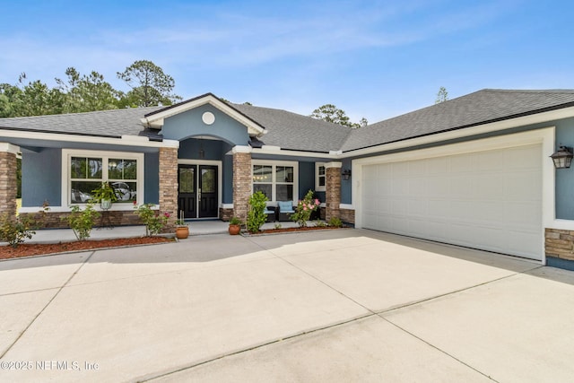 75652 Edwards Rd, Yulee, FL 32097 - view of front of property featuring stucco siding, concrete driveway, a garage, a shingled roof, and a porch