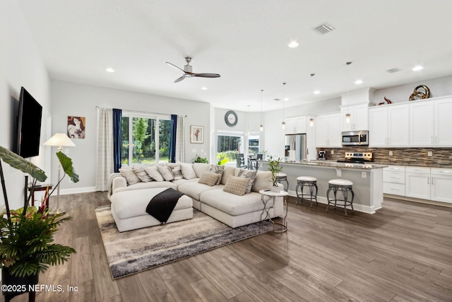 75652 Edwards Rd, Yulee, FL 32097 - living area featuring wood finished floors, ceiling fan, and recessed lighting