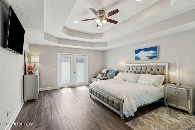 75652 Edwards Rd, Yulee, FL 32097 - bedroom featuring access to outside, wood finished floors, french doors, recessed lighting, and a tray ceiling